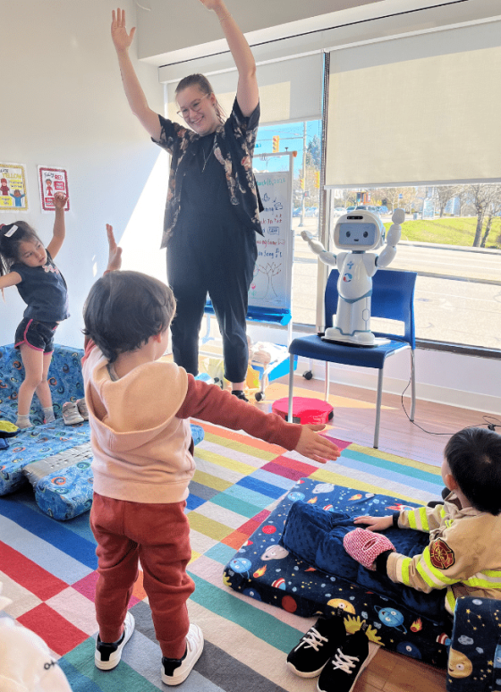 Teacher leading children in Music & Movement program