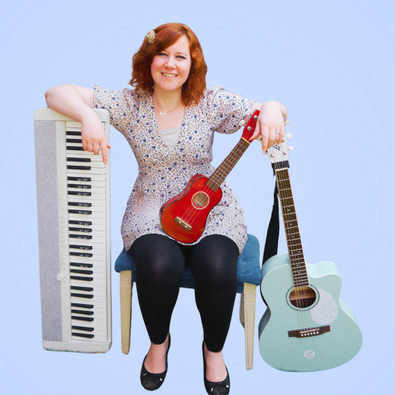 Marisa Levenson of Young Folkies surrounded by a piano, ukulele and guitar